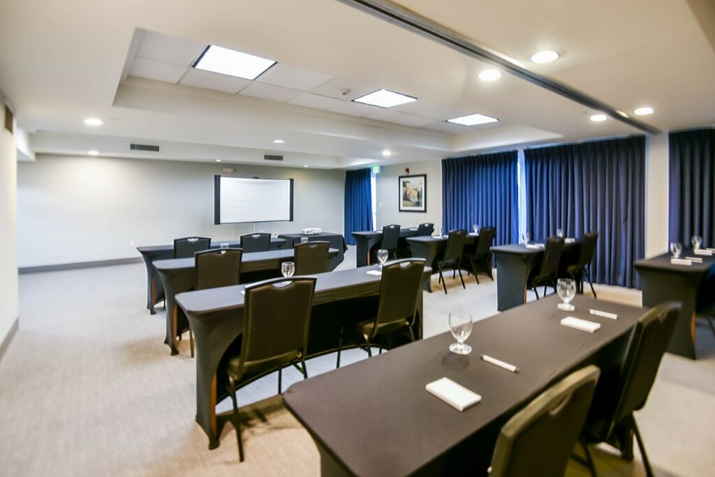 Modern conference room setup with projector screen.